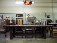 Reproduction dining/conference table shown with inlaid Gustav Stickley-Harvey Ellis design reproduction dining chairs. Beginning with the chair at the left end of the table, oak inlaid chair with arched crest rail, the same design in Cherry, Custom over-sized Stickley-Ellis inlaid side chair, and an Accurate replica Stickley-Ellis inlaid side chair, original size. 